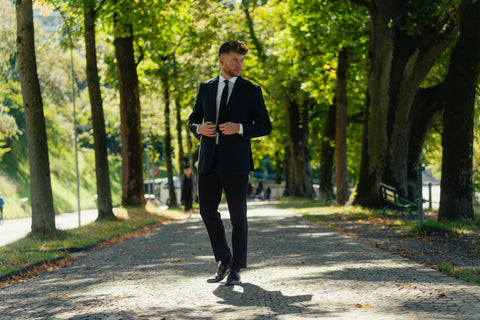 Young man in a suit in the park