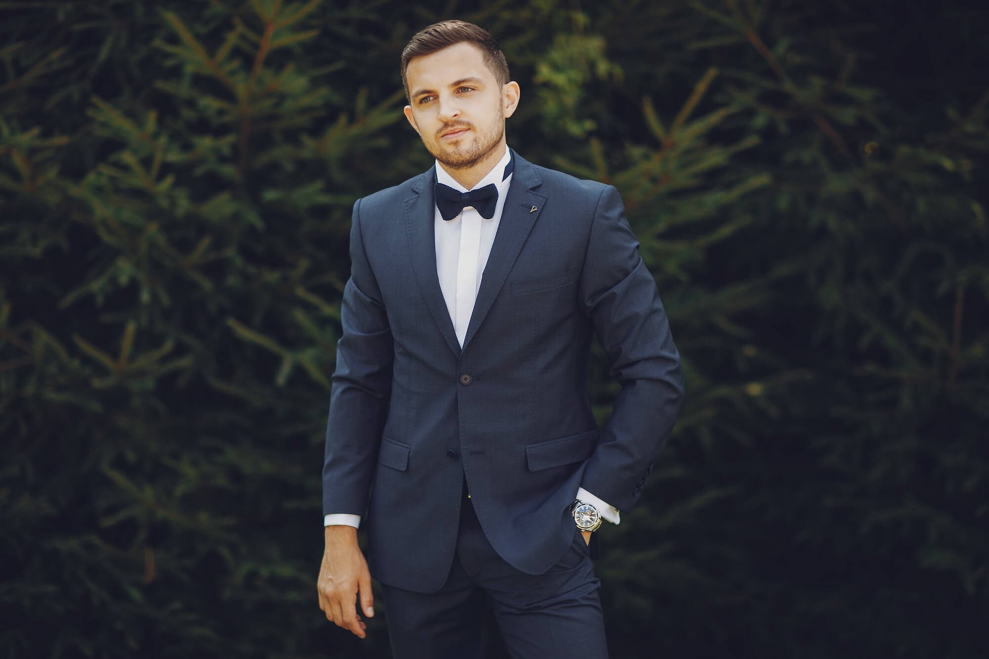 Wedding guest or groom in a suit with bowtie