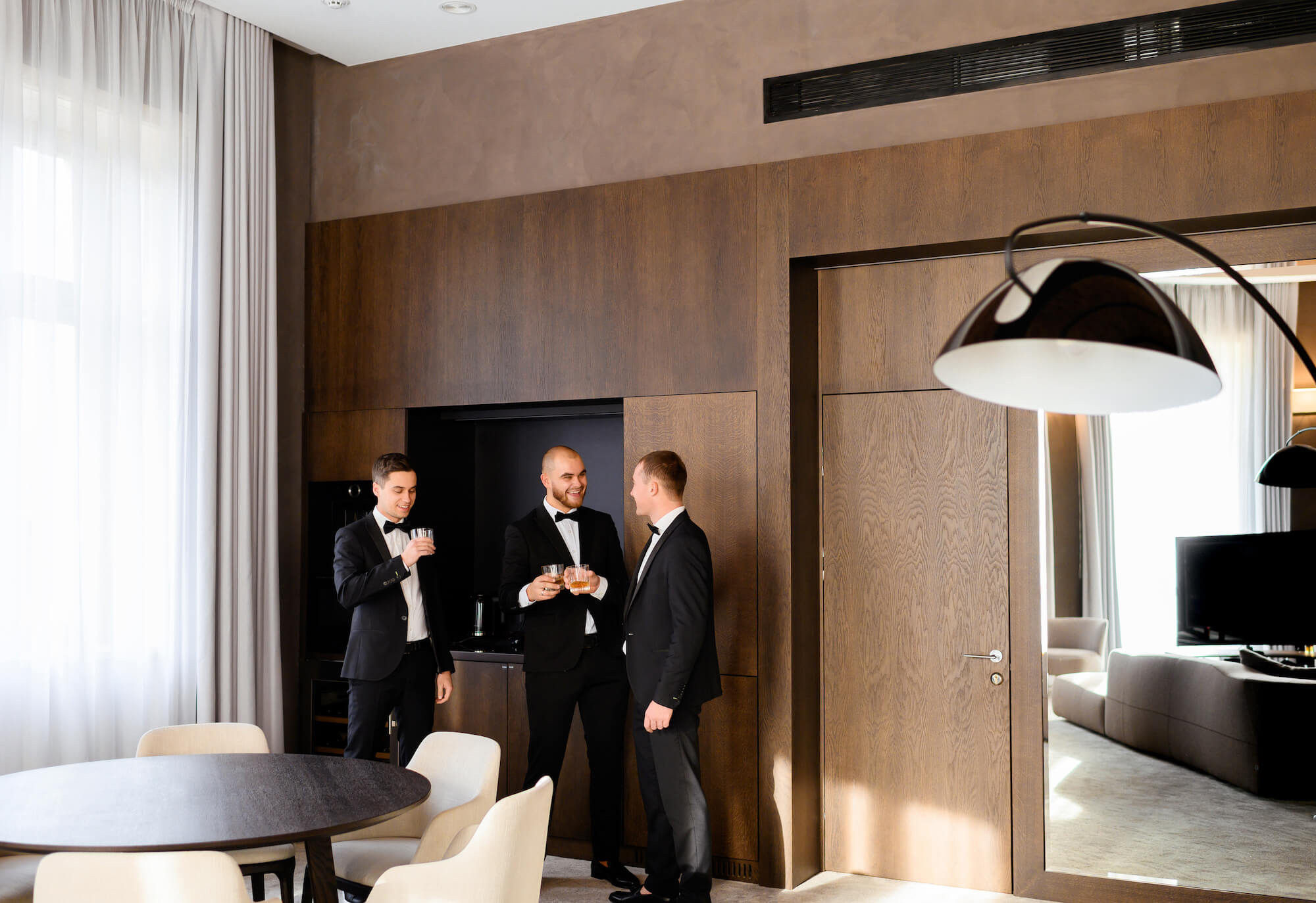 Groom with wedding guests in tuxedo